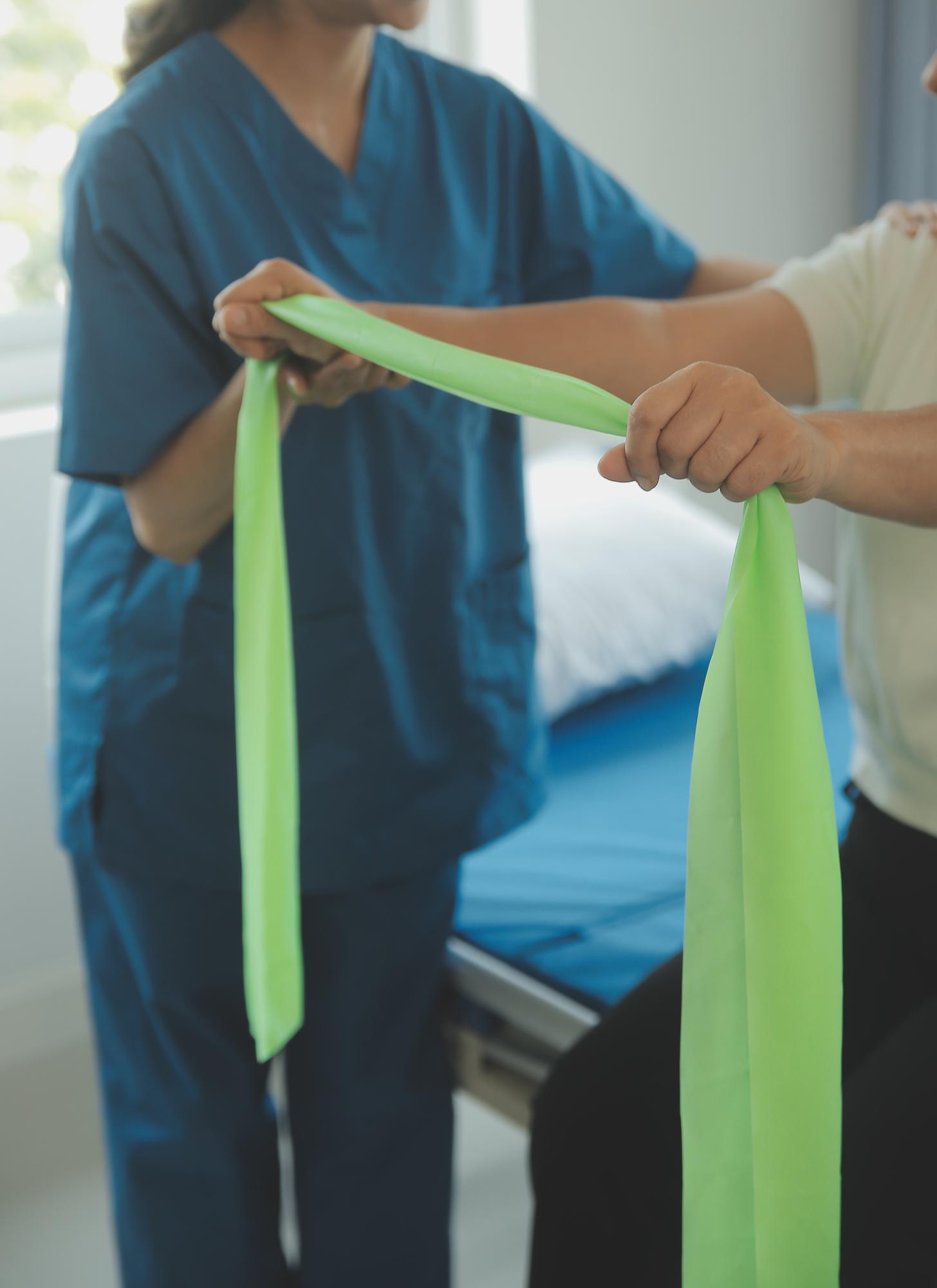 Therapist working on post-operative rehabilitation with resistance band