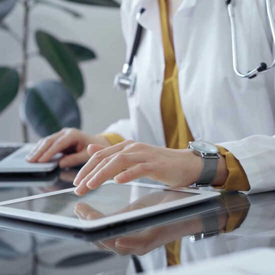Clinician reviewing patient records on a tablet
