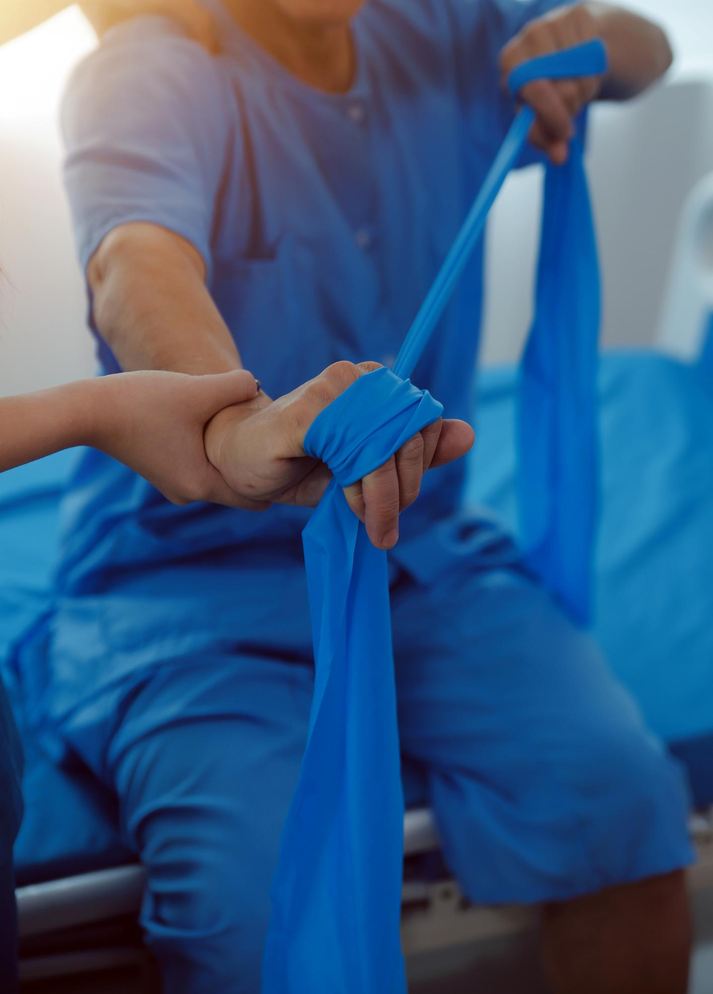 Patient performing post-operative rehabilitation with resistance band
