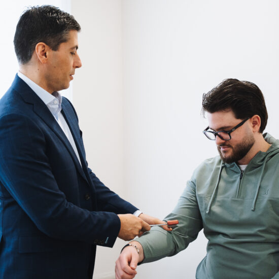 Physician performing a clinical reassessment with a patient